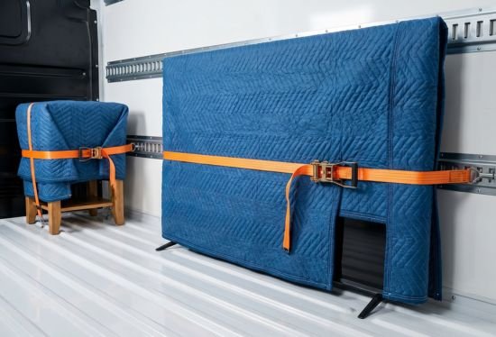 Belongings securely strapped and blanket-wrapped inside an RB Removals van, showcasing fully insured transport.