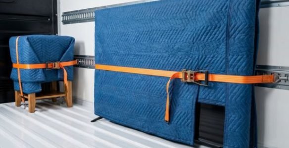 Belongings securely strapped and blanket-wrapped inside an RB Removals van, showcasing fully insured transport.