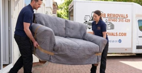 Professional RB Removals team safely carrying wrapped furniture out of a residential property during a Lytham St Annes house move.
